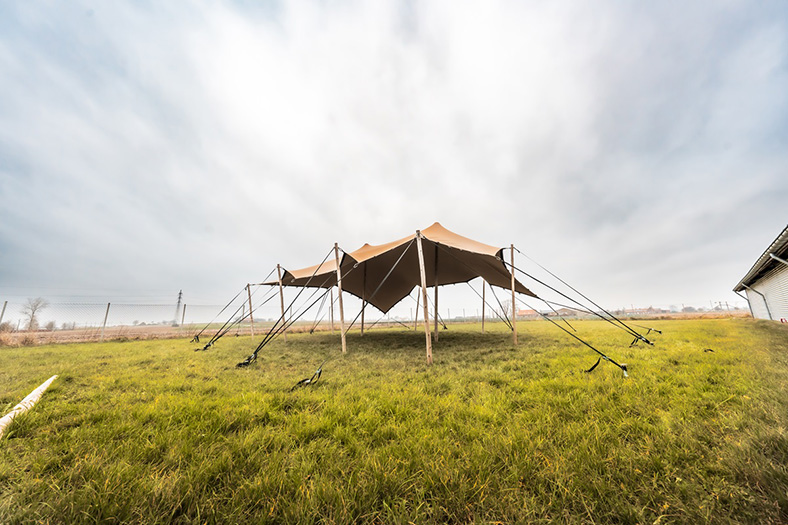 stretch tent with loops and wooden poles